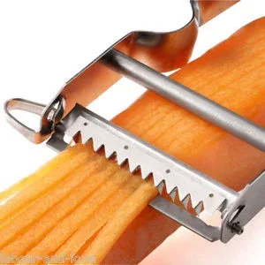 A carrot being serrated vegetable peeler spaghettifying a carrot. A cutter takes a thin slice off the surface of the carrot, much like a traditional peeler, but over top is a second serrated cutter, which simultaneously cuts the slice into thin spaghetti-like noodles.