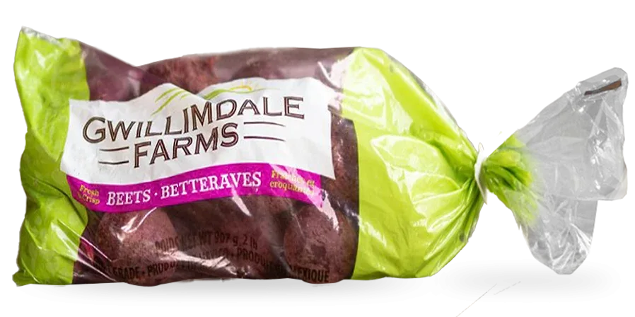 A 2lb bag of Gwillimdale farms beets. The top and bottom of the bag are solid light green, with a repeating pattern of various root vegetables, and farm imagery (barns, tractors, etc.). The middle 75% of the bag is transparent, showing the beets inside, with a large white Gwillimdale Farms logo across part of the otherwise clear portion.